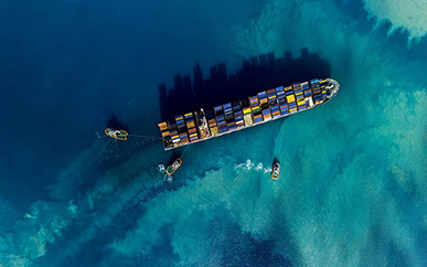 Full loaded ship in the sea from above with ships around it