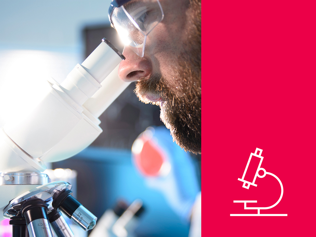 Close up of man looking into a microscope