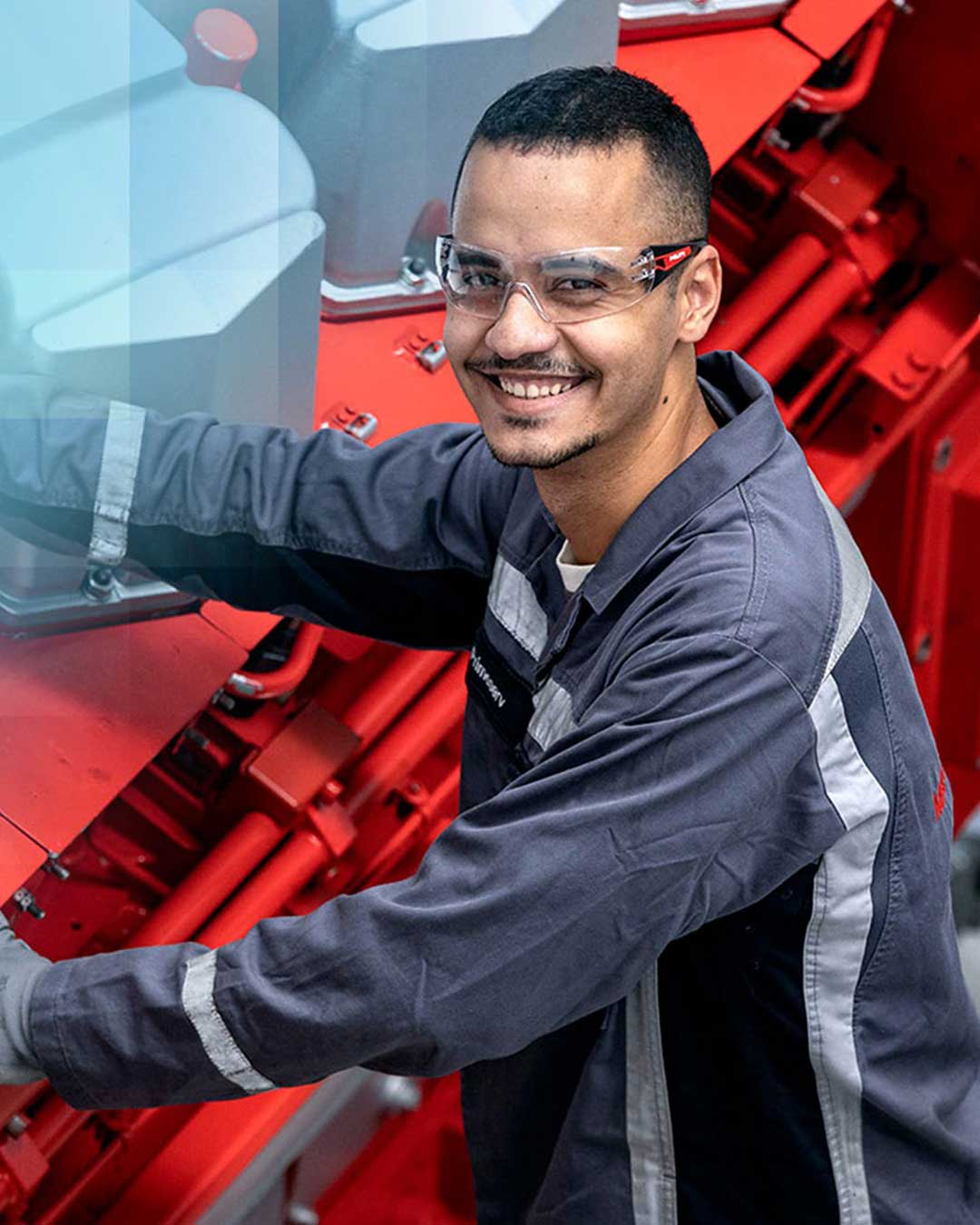 man standing on an engine looking into the camera