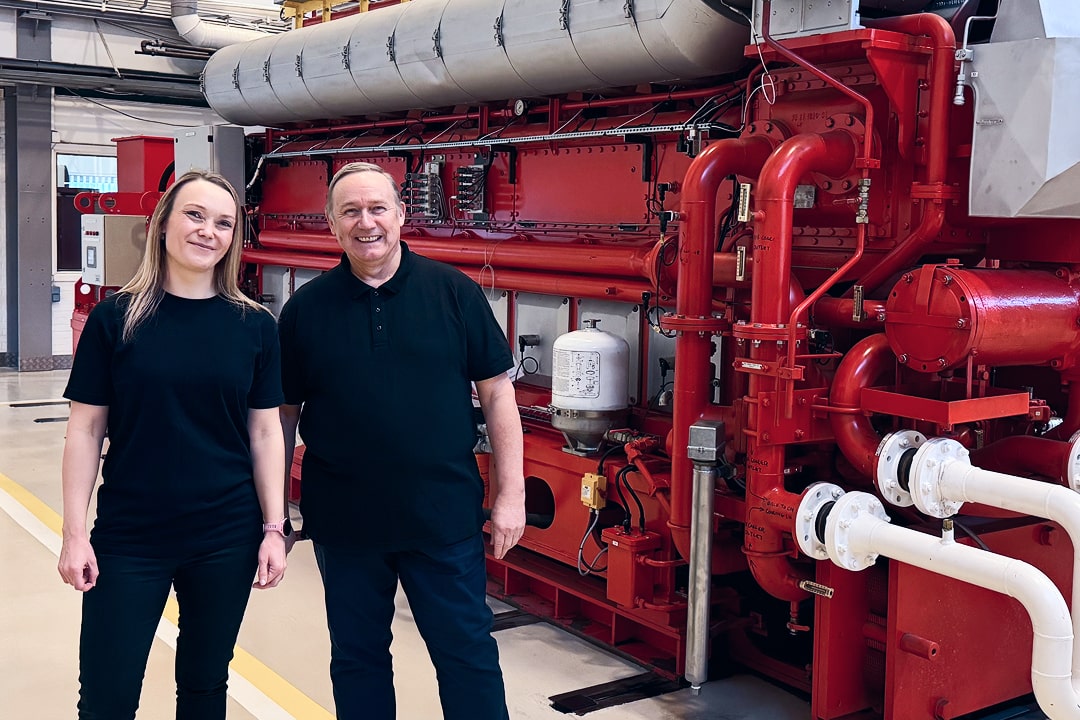 man and woman in front of red engine