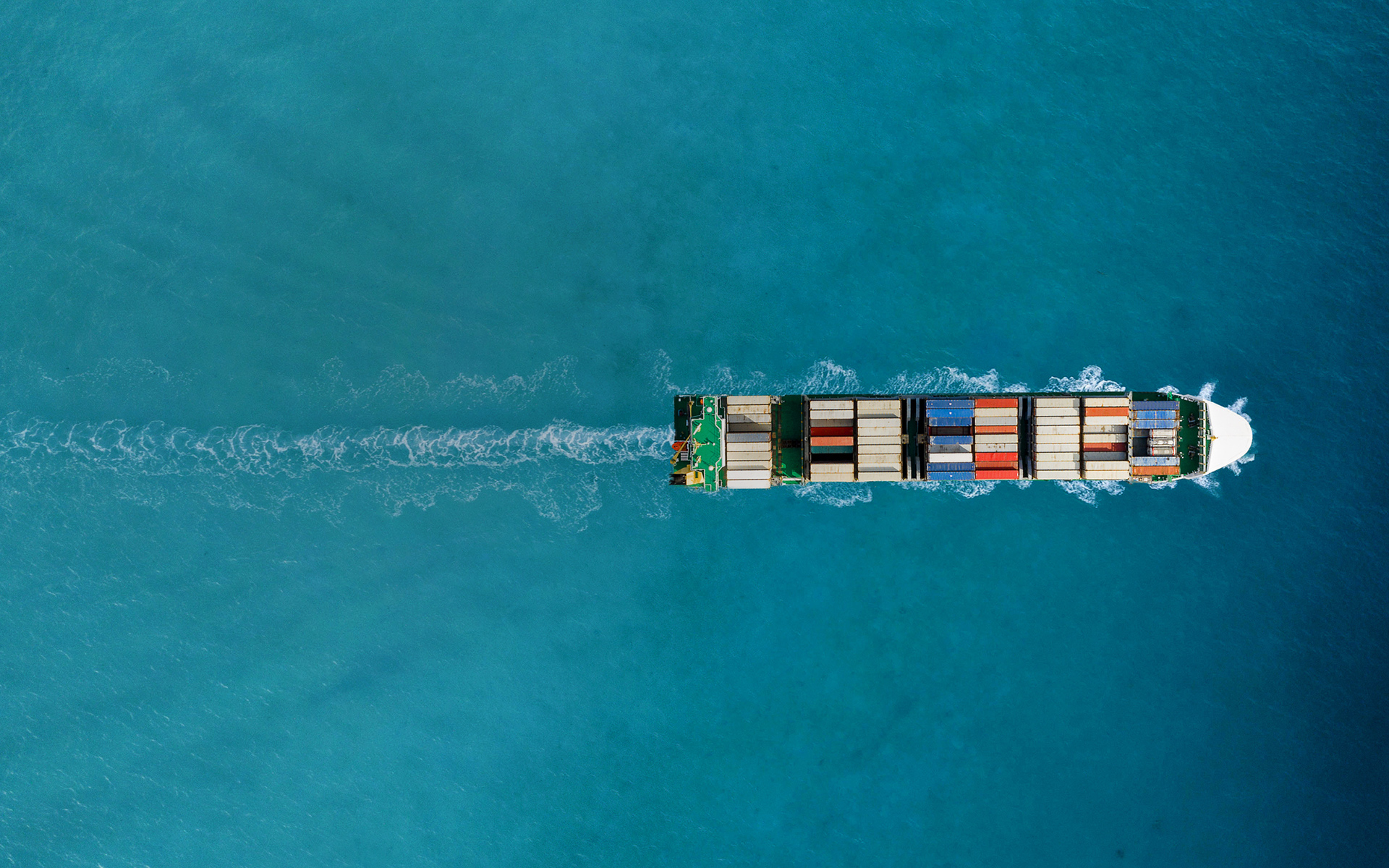 Ship from above sailing through the sea