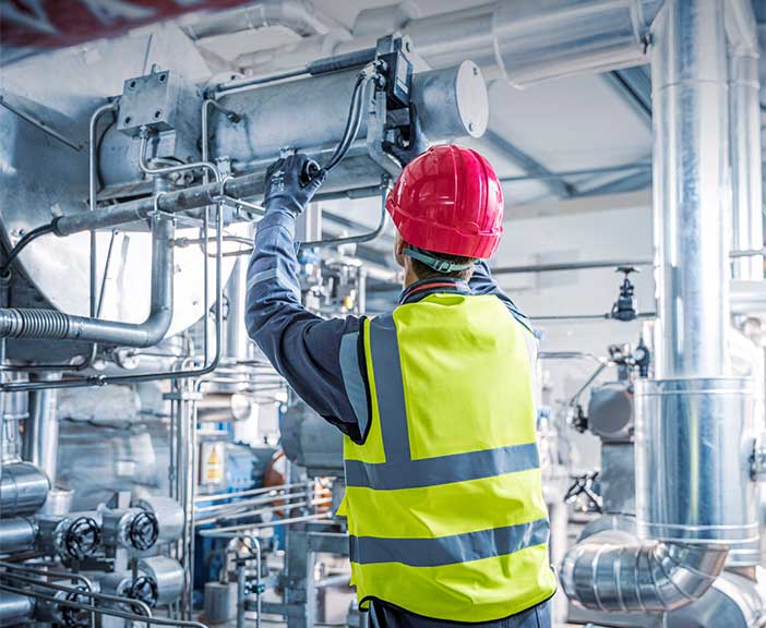 Service employee working on an engine