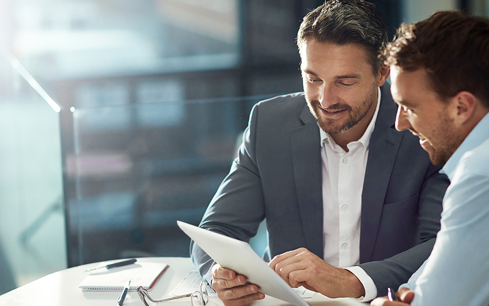 two pleople checking a paper