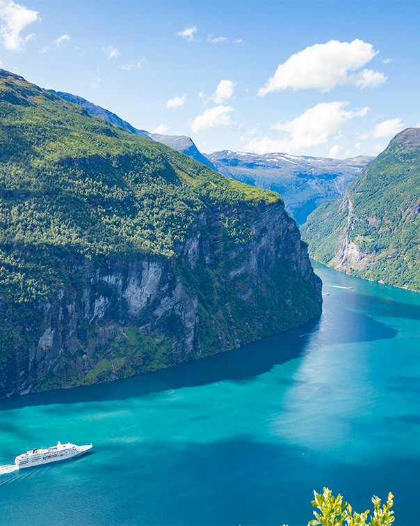 ship cruising through fjord 