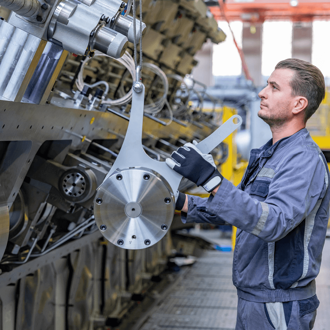 service employee in front of a big four-stroke engine