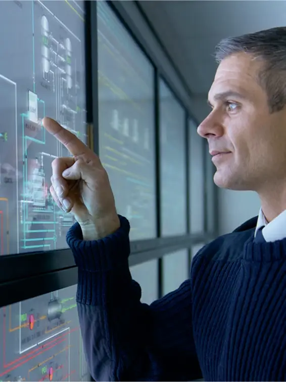 man standing in front of a big screen and pointing on somethins