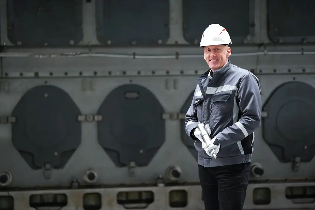 Quality engineer in front of marine engine