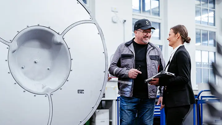 two people talking next to a turbocharger